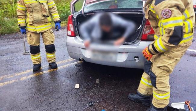 Homem é encontrado dentro de porta-malas de carro acidentado; condutor e passageira são presos