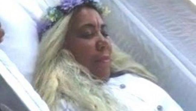 Mulher aluga caixão e ensaia funeral no quintal