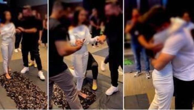 Mulher anda sobre cacos de vidro durante dinâmica de evento com empresários em hotel de luxo